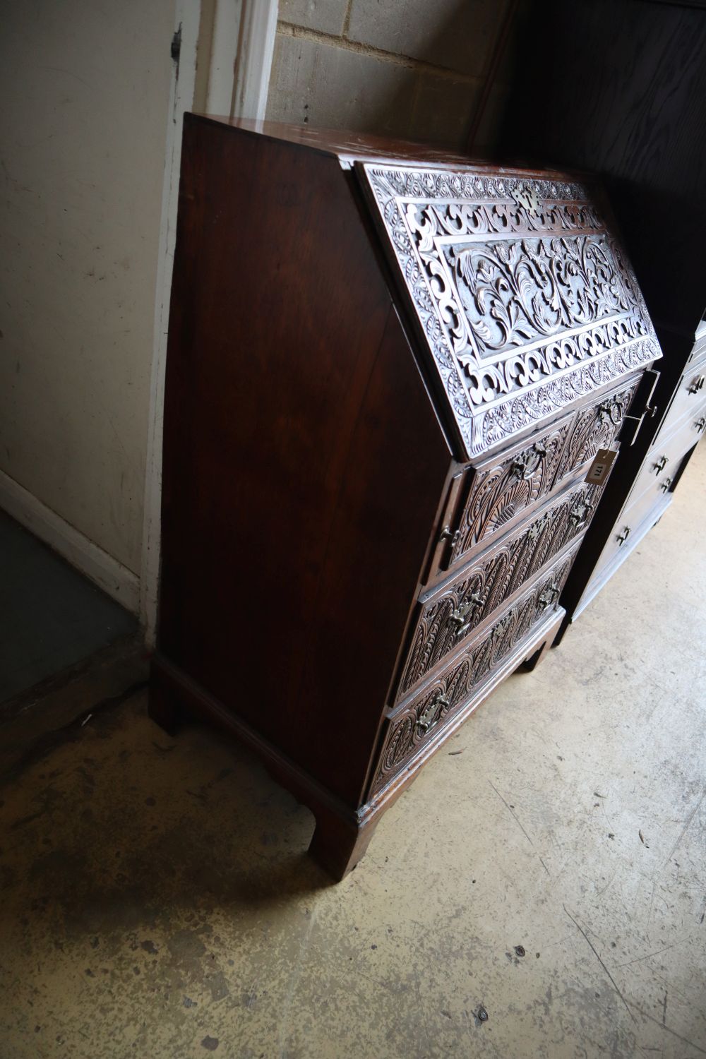 A small 18th century walnut bureau, later carved, width 76cm depth 47cm height 103cm